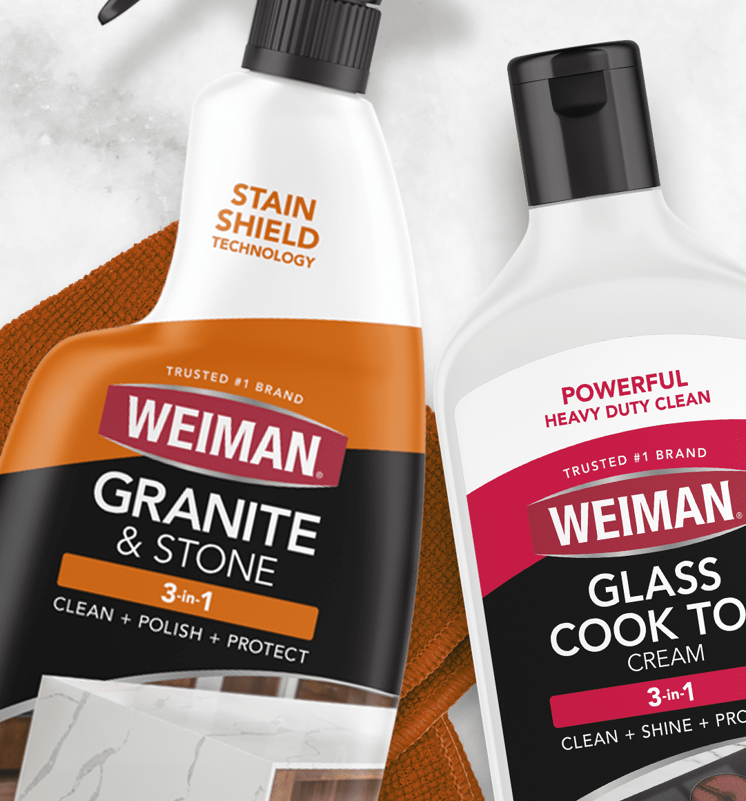 Two Weiman cleaning bottles—Granite & Stone and Glass Cook Top—showing 3-in-1 cleaning, polishing, and protecting labels.